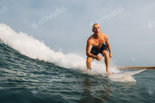 Preview: guy swims on a surf on a blue wave