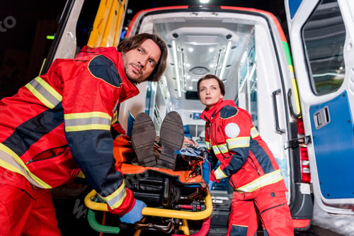 Preview: Serious paramedics transportating patient in ambulance car