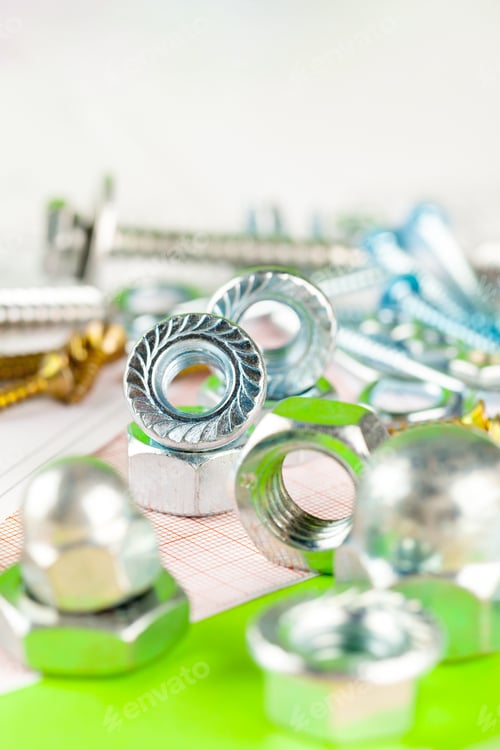 Preview: technology and metalworking. Metal bolt and nut on printed drawings background