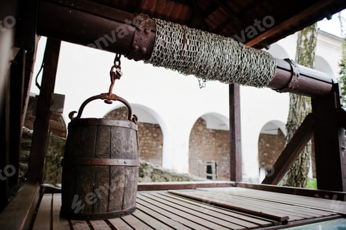 Preview: Old wooden water well with pulley and bucket. Palanok castle