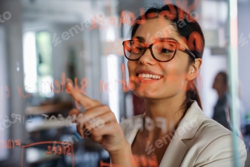 Preview: Woman working and writing on the glass board in office. Business, technology, research concept