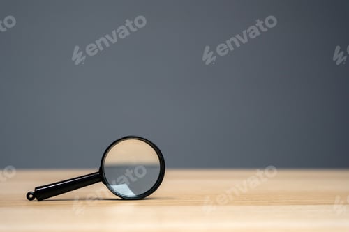 Preview: Magnifying glass on a grey background.