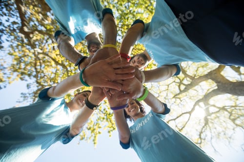 Preview: Volunteers forming a hand stack in the park