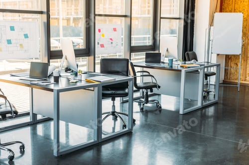 Preview: working tables with computers and laptops in business office