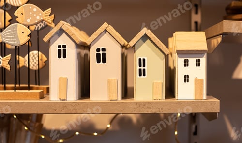 Preview: Wooden houses on the shelf, home decor detail.