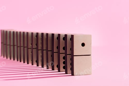 Preview: Row of domino tiles on pink studio background