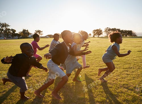 Preview: Elementary school kids running together in an open field