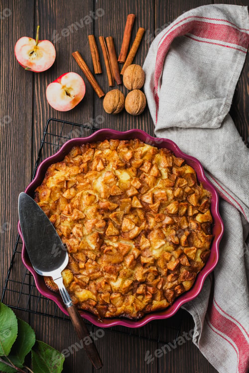 Preview: Apple and cinnamon homemade pie with walnuts and custard on an old concrete background. Rustic style