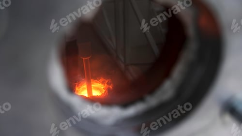 Preview: Close up of small window inside metal barrier for observing melting process, modern technologies