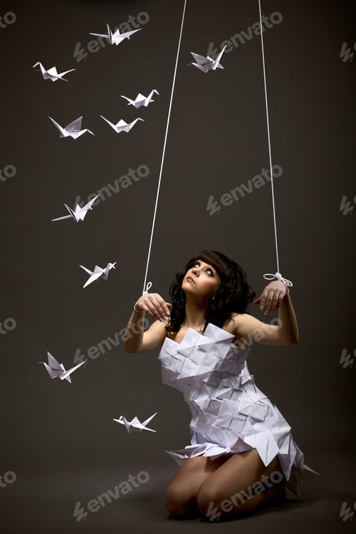 Preview: Sad beautiful young caucasian girl in origami