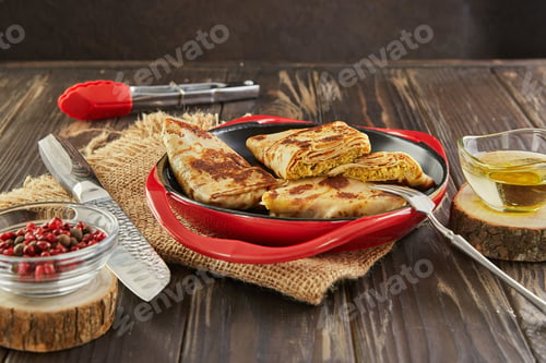 Preview: Pancakes with meat on dark wooden background
