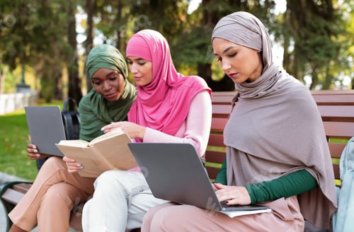 Preview: Three Islamic Women Learning Using Computers And Reading Books Outdoor