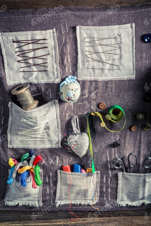 Preview: Vintage sewing mat with scissors, threads and needles in tailor workshop