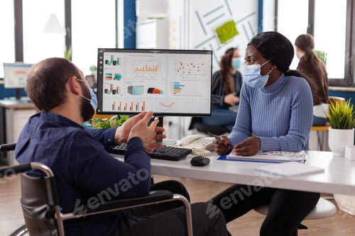 Preview: Handicapped businessman in wheelchair wearing protective face mask