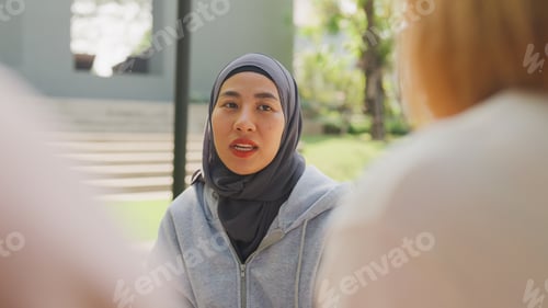 Preview: Close-up head shot young Asia female psychology meeting patients at group therapy in park.