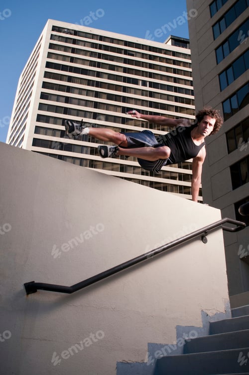 Preview: Athlete jumping over urban wall