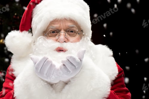 Preview: Portrait of Santa Claus blowing snowflakes from hands