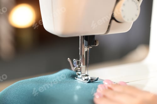Preview: Woman working with sewing machine on blurred background, macro view
