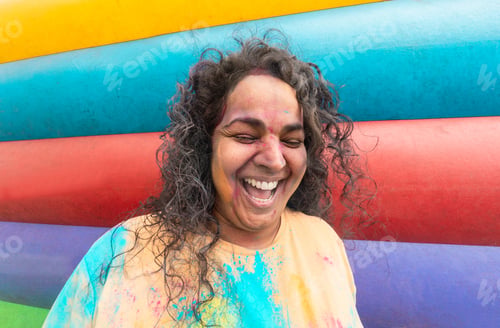Preview: Indian woman having fun during holi festival outdoor - Summer, lifestyle, party and vacation