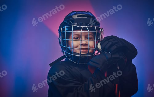Preview: Young hockey player posing in uniform for a photoshoot in a studio