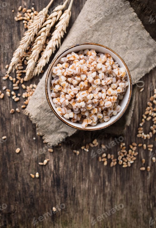 Preview: Bowl of barley porridge on wooden background