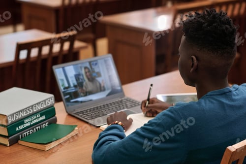 Preview: Student Engaged in Online Class with Books