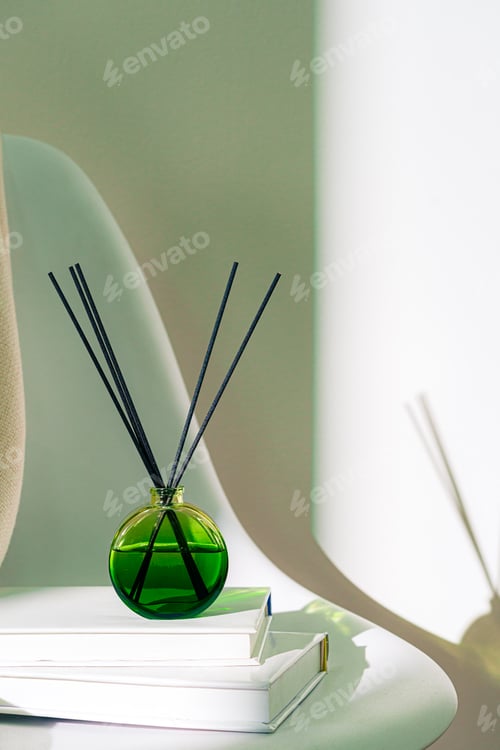 Preview: Liquid home perfume in glass diffuser with sticks on chair