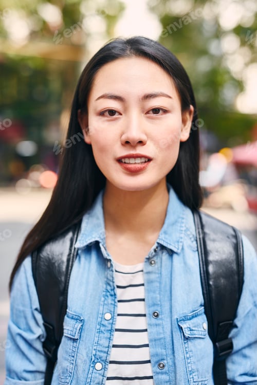 Preview: Portrait of Vietnamese young woman with backpack in the city