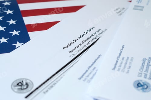 Preview: I-130 Petition for alien relative blank form lies on United States flag with envelope from
