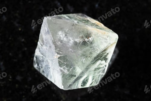 Preview: sample of single raw fluorite crystal on black