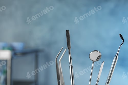 Preview: Professional dentist tools on blurred background, space for text