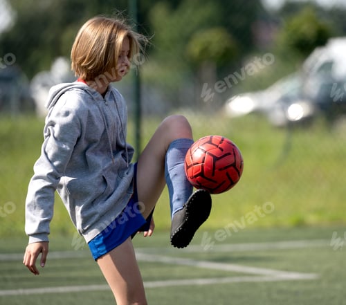 Preview: Child Kicks Ball With Foot In Close-Up