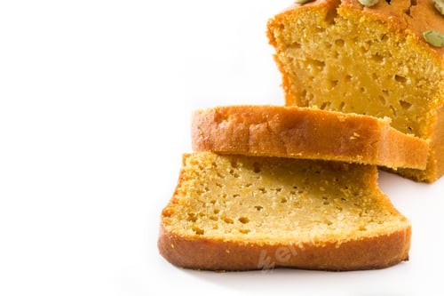 Preview: Sliced pumpkin bread loaf with pepitas on white background