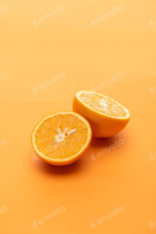 Preview: ripe juicy orange halves on colorful background