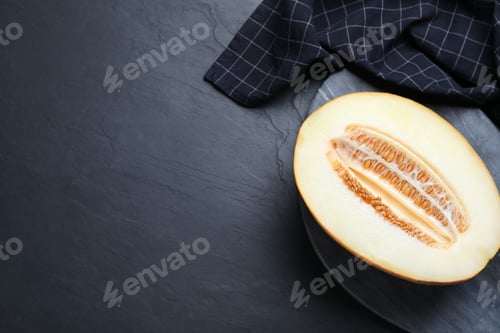 Preview: Delicious honey melon on black table, top view. Space for text