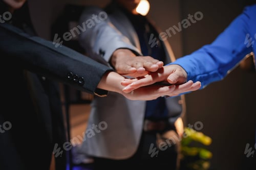 Preview: Business team joining hands together showing teamwork and cooperation
