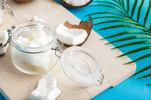 Preview: Coconut pieces on wooden board on blue background