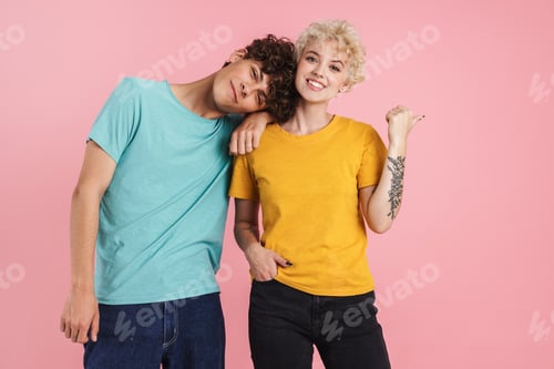 Preview: Cheerful young teenage couple poointing