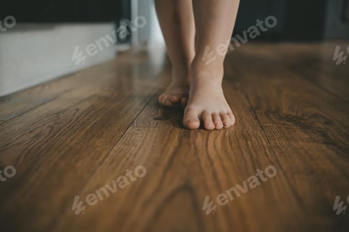 Preview: children's bare feet feet walking at home on the floor