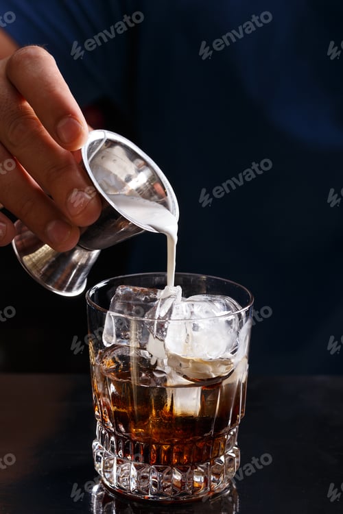 Preview: Bartender prepares a white russian cocktail