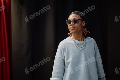 Preview: Young Adult Black Man Wearing Sunglasses Performing at Talent Competition