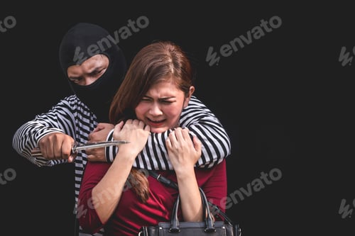 Preview: Thief threatening with knife, young woman scared and screaming while arrested by bandit.