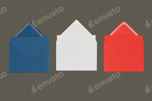 Preview: close-up view of blue, white and red envelopes isolated on black