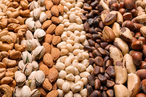 Preview: Organic mixed nuts as background, closeup. Healthy snack