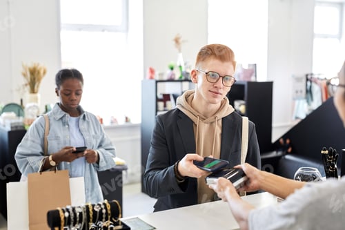 Preview: Customer paying in clothing store