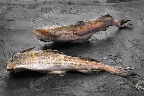Preview: Frozen pollock carcass on wooden table