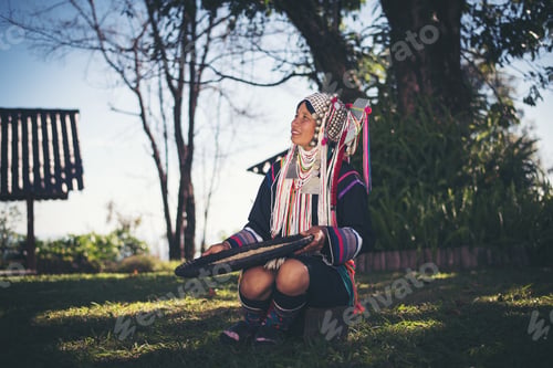 Preview: Akha in the north of Thailand enjoying coffee from shell by bamboo basket with traditional cloth.