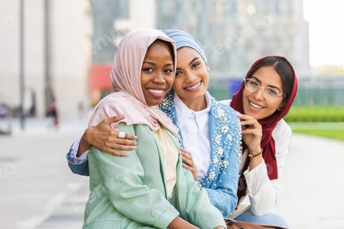 Preview: Beautiful muslim girl wearing hijab bonding outdoors
