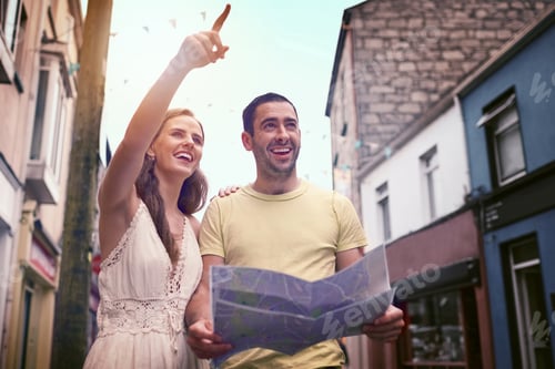 Preview: Shot of a happy young couple reading a map while exploring a foreign city together
