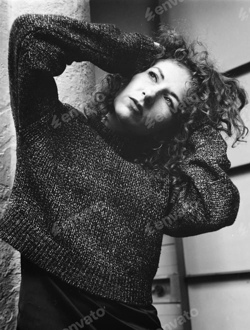 Preview: Analogue film portrait of woman with hand on her head.